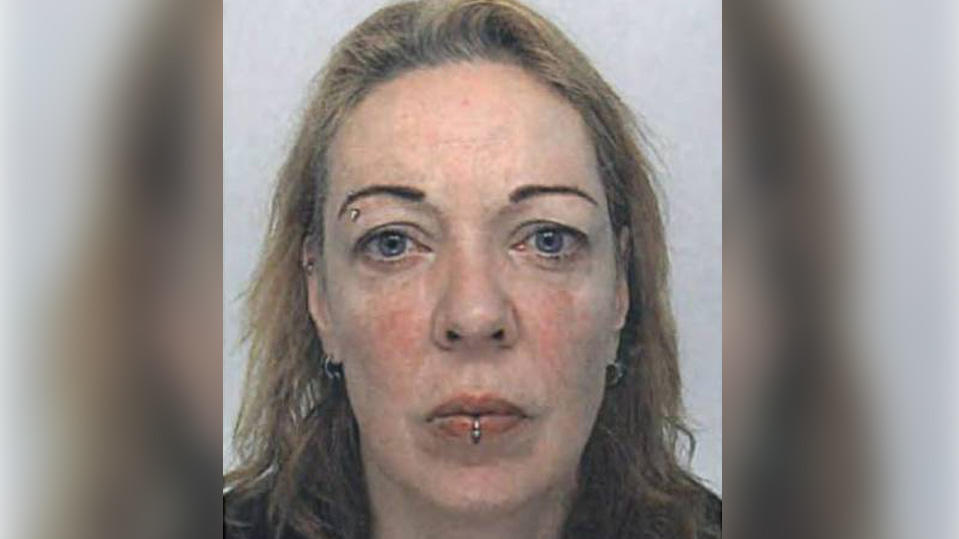Eine 55-jährige Frau mit blonden Haaren schaut in die Kamera
